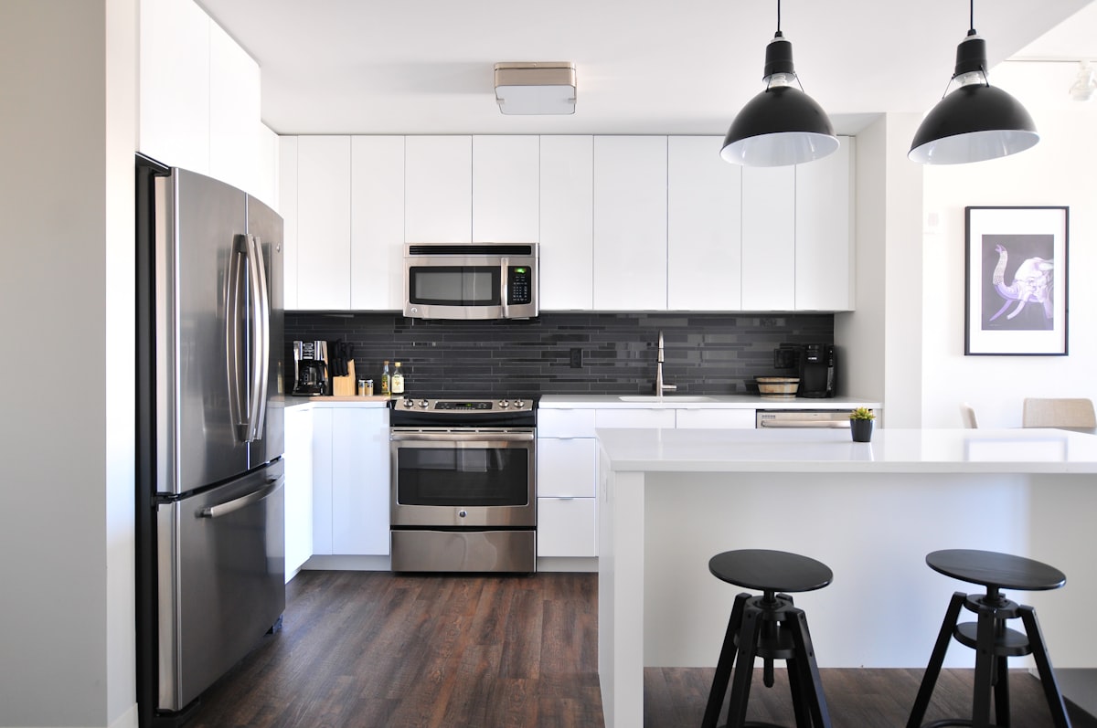 Open-plan kitchen with wood flooring over underfloor heating
